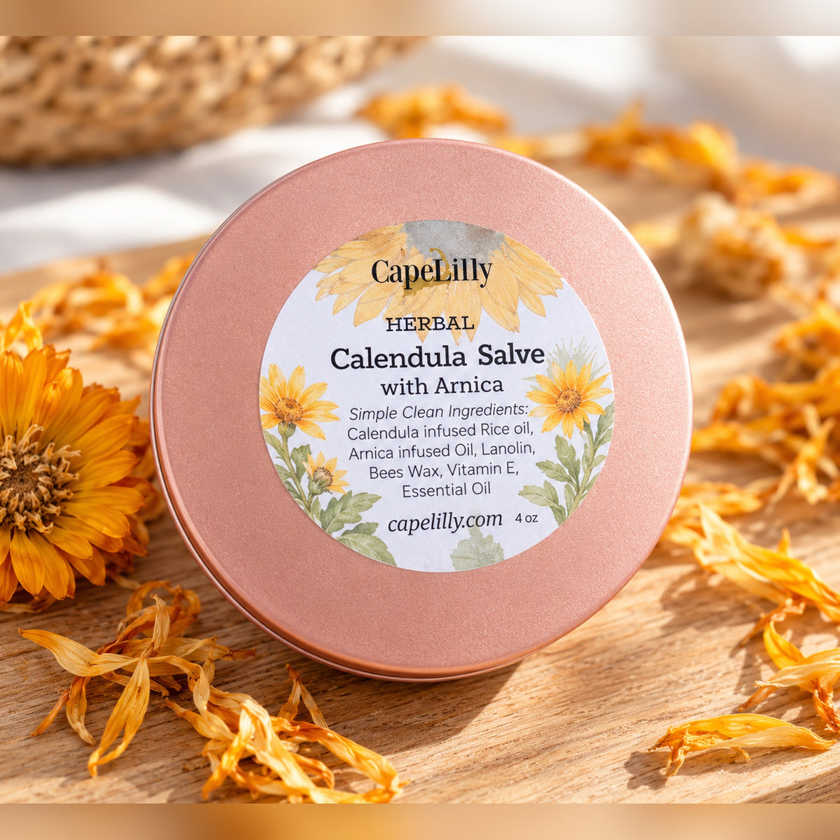 CapeLilly Herbal Calendula Salve with Arnica tin with dried calendula petals on a wooden board
