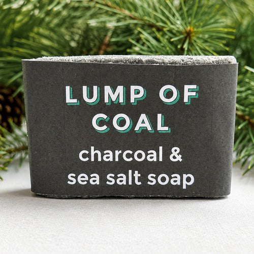 Cape Lilly Lump of Coal charcoal and sea salt soap in holiday wrapper with pine branches